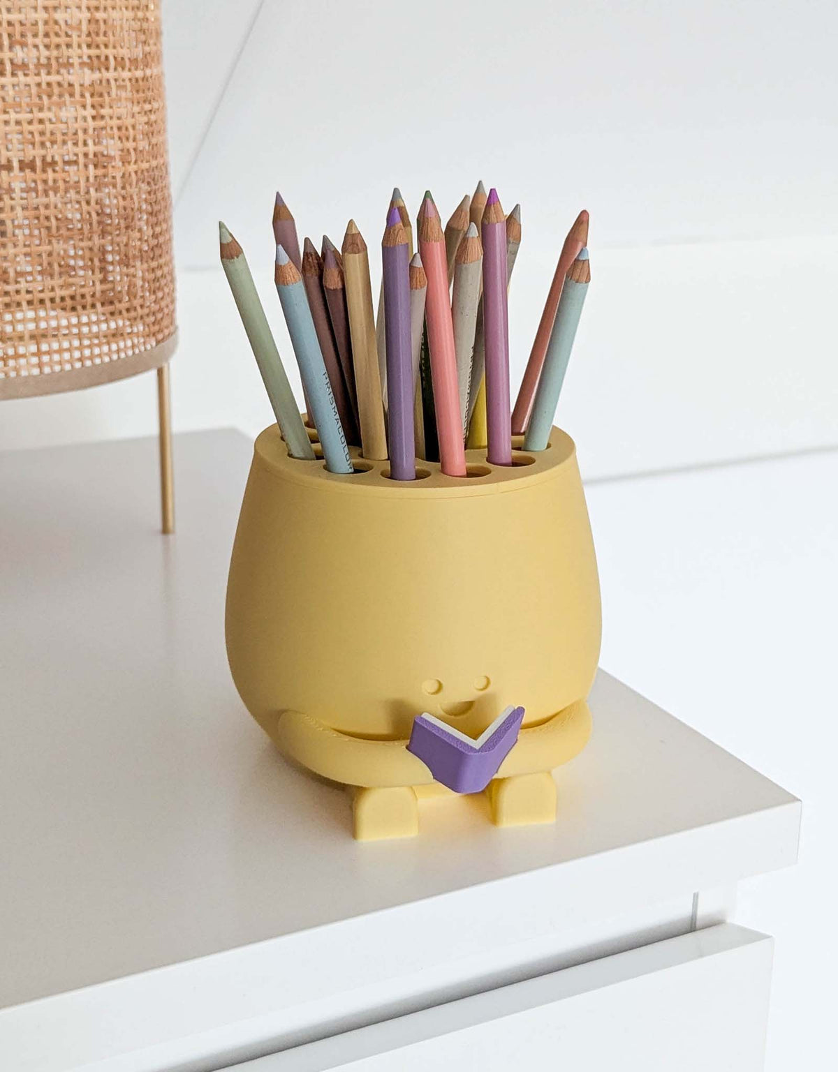 Happy pencil holder with a book