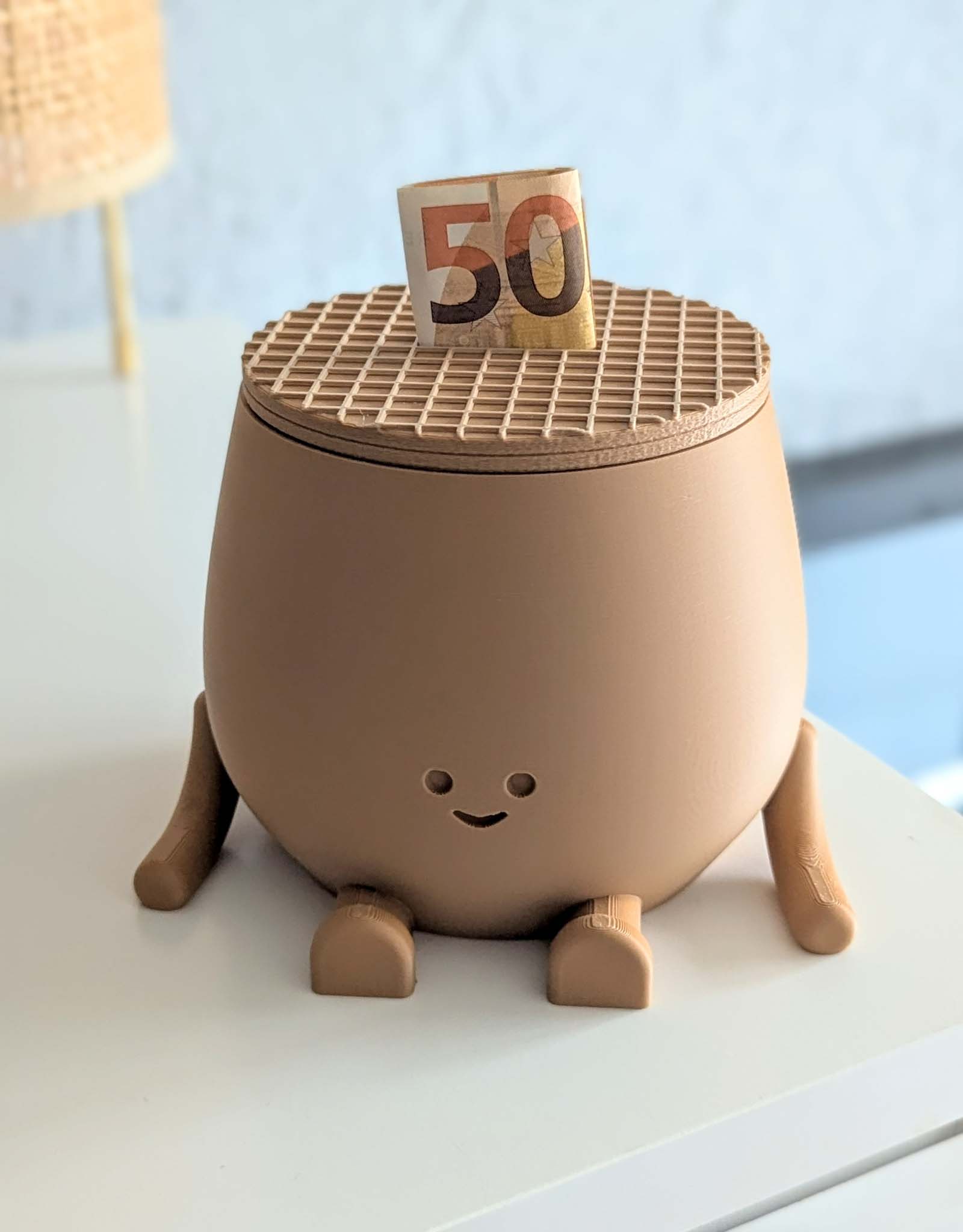 Beige piggy bank with the look of a stroopwafel, the dutch cookie. 