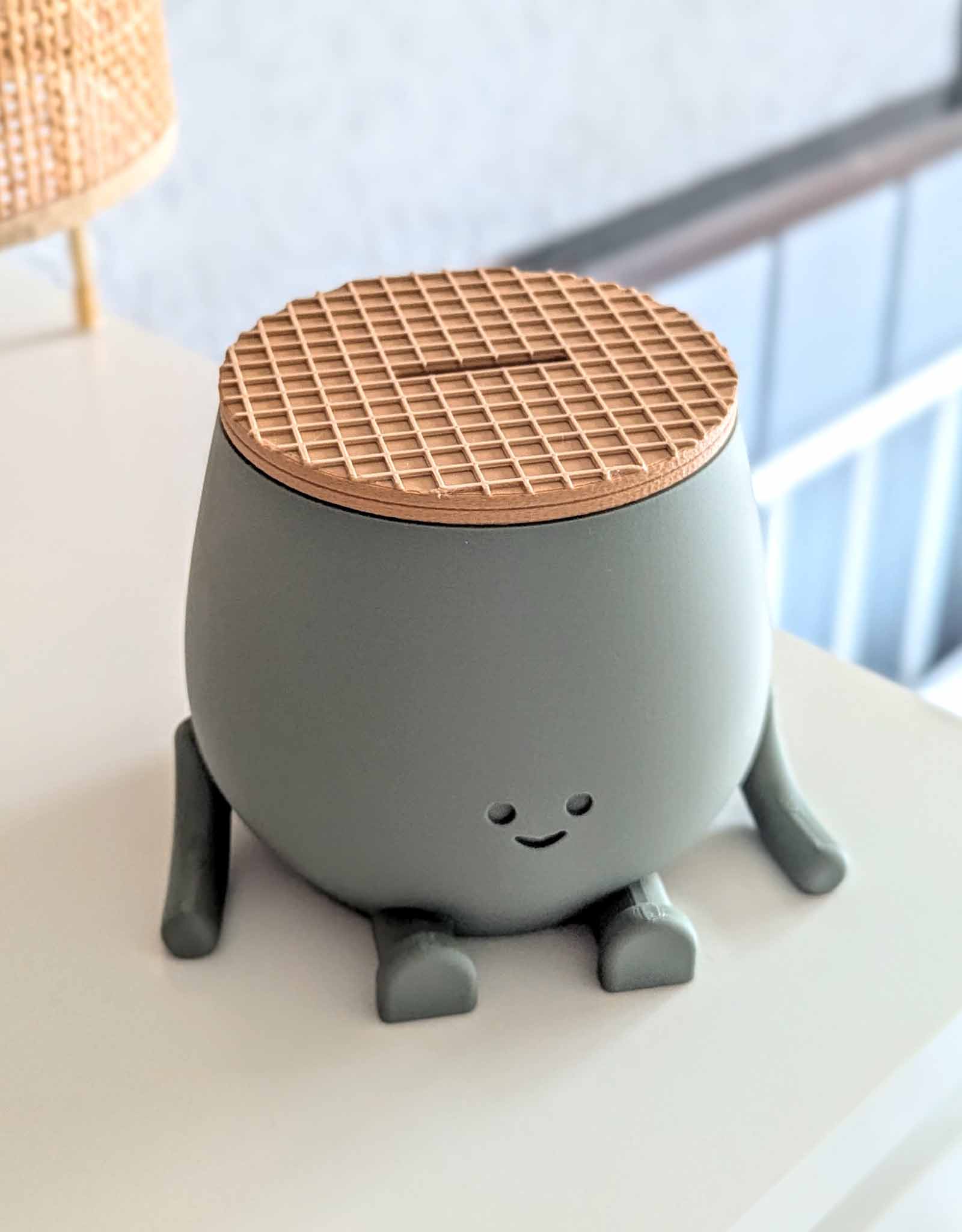 Dark green piggy bank with the look of a stroopwafel lid, the dutch cookie. 