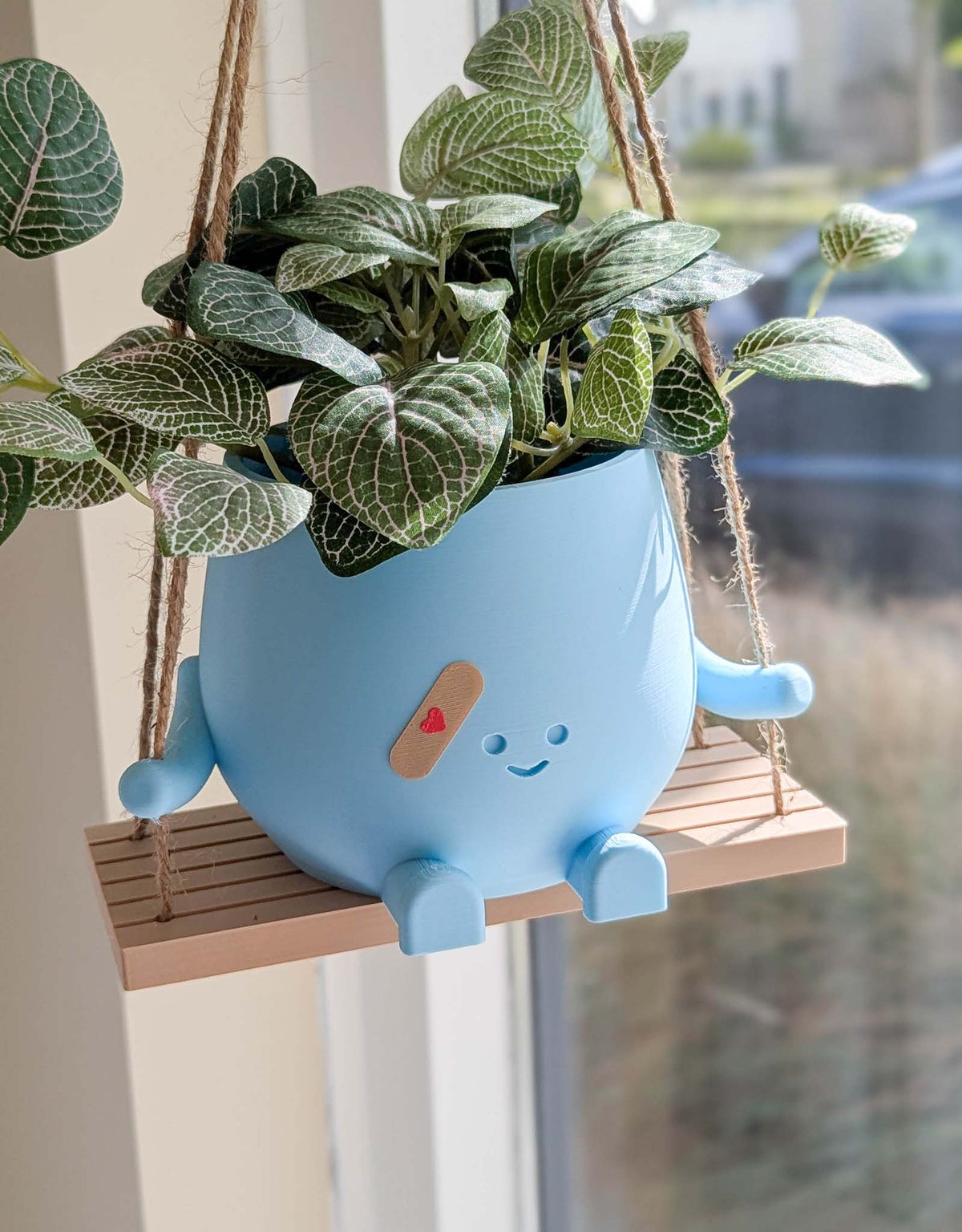 Happy imperfect plant pot on a swing