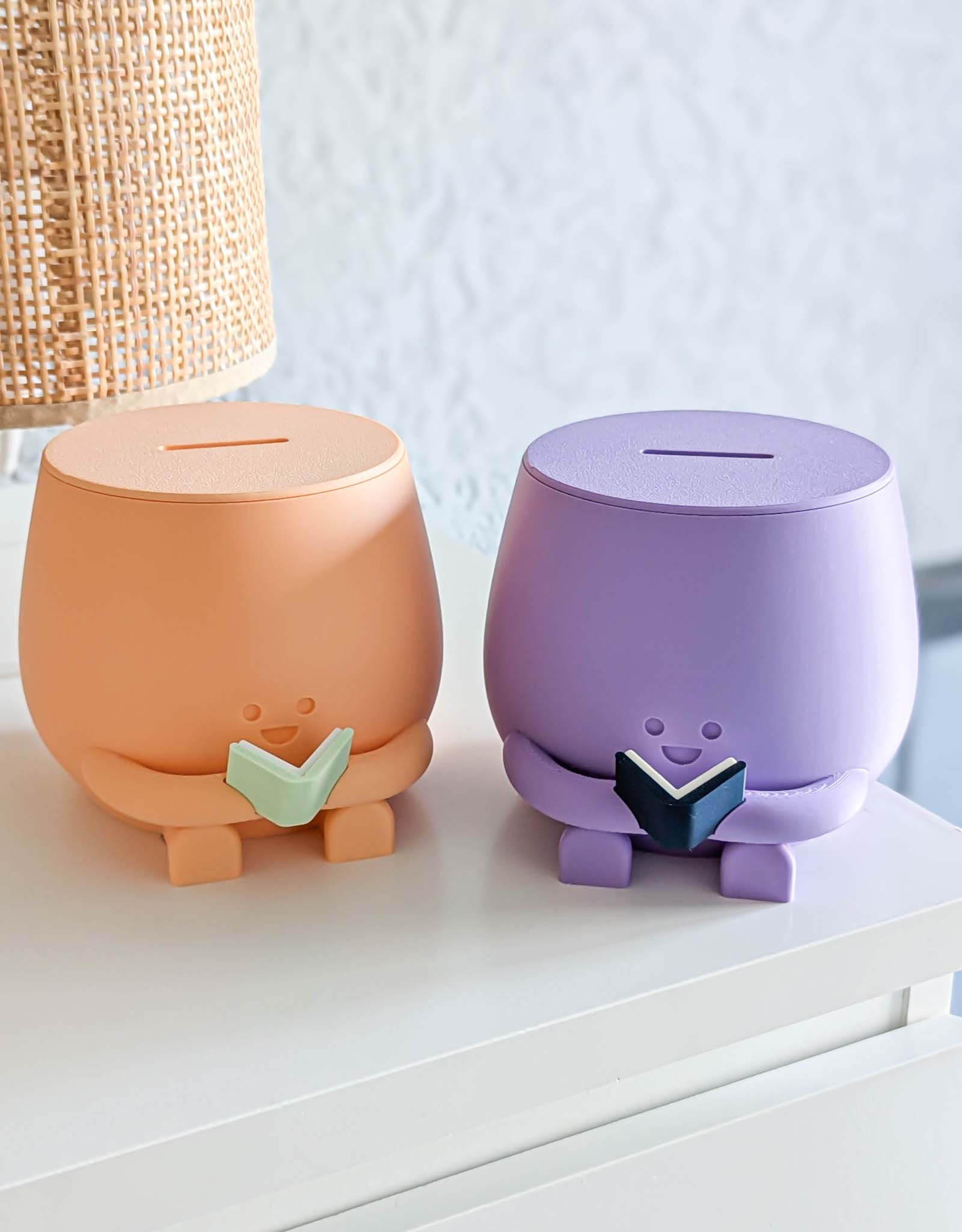 Peach and purple piggybank with happy face reading a book