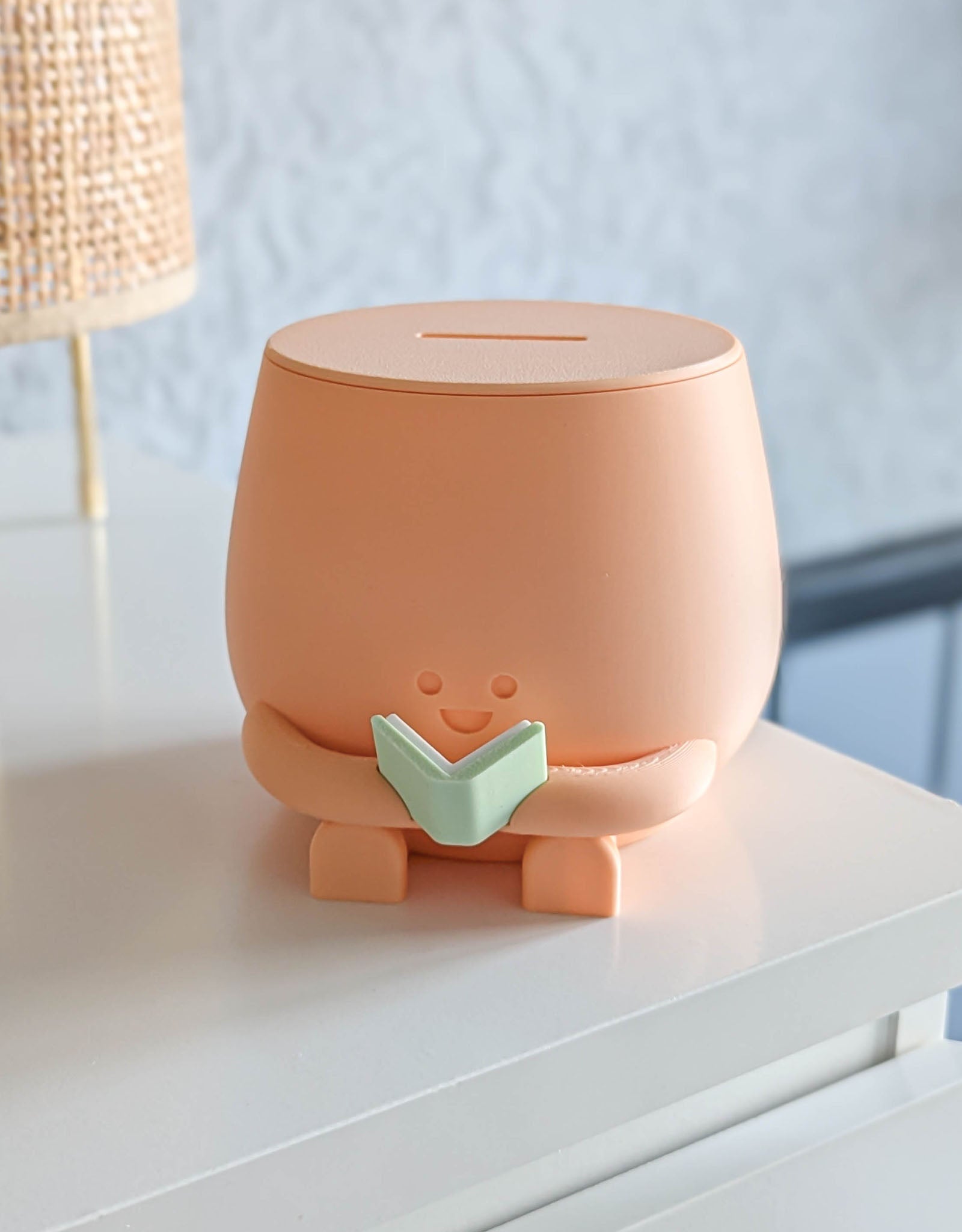 Piggybank with happy face reading a book