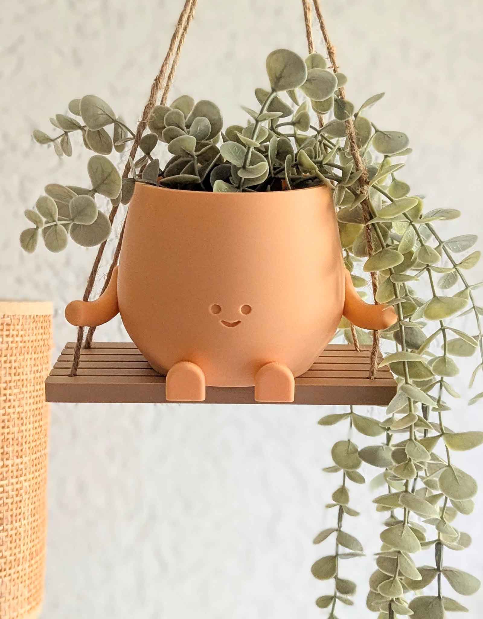 Happy imperfect plant pot on a swing