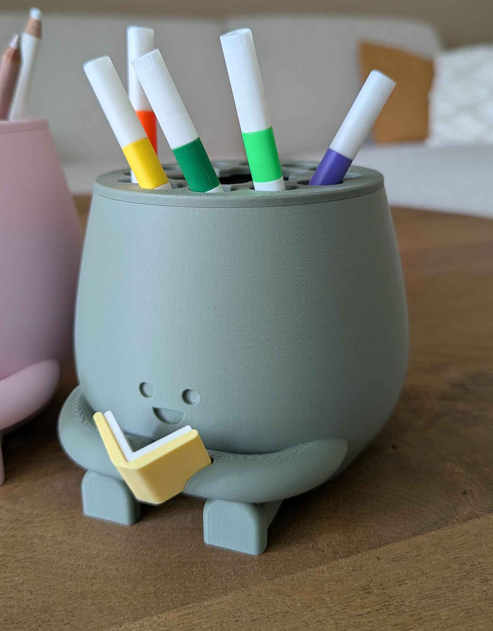 Happy pencil holder with a book