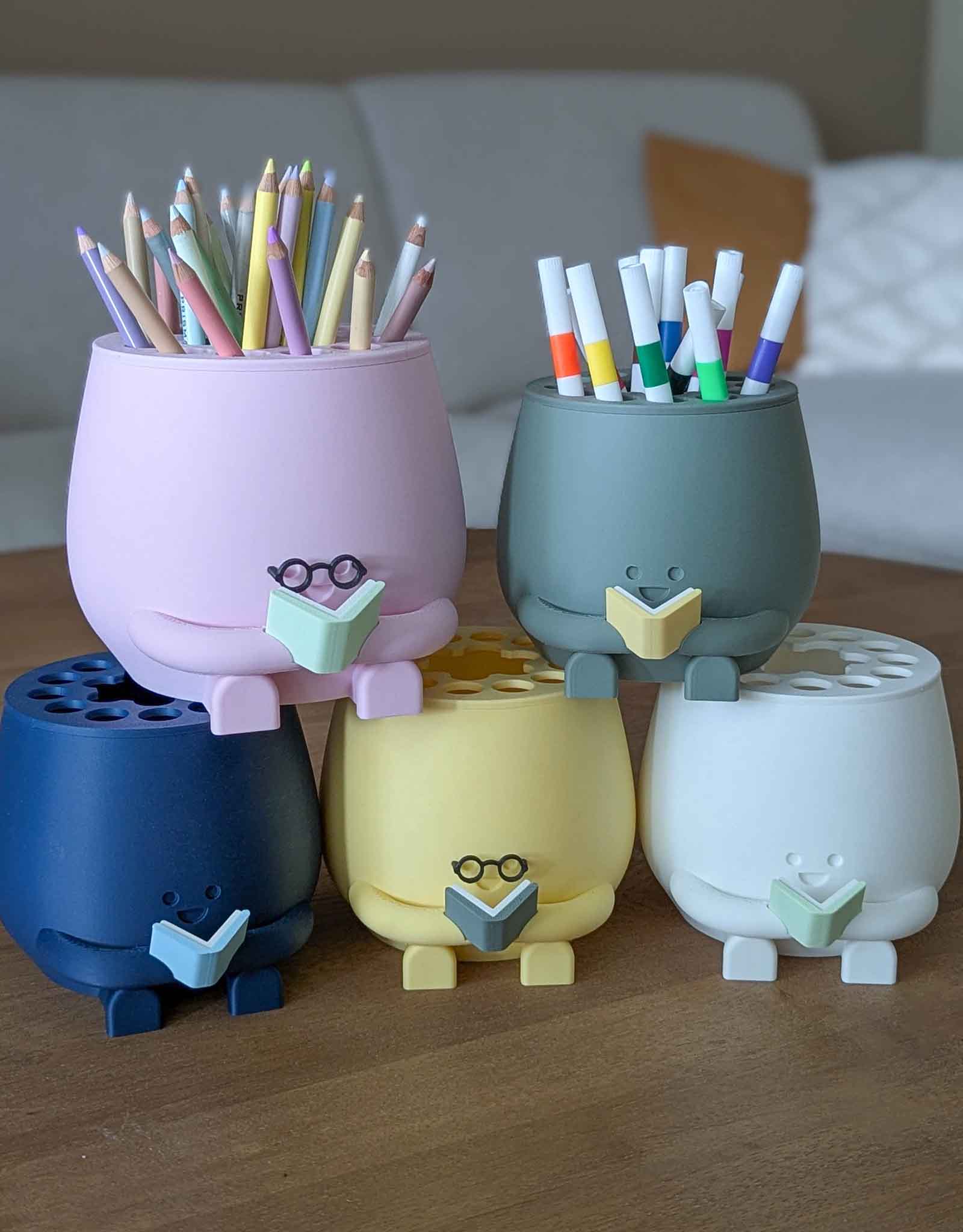 Happy pencil holder with a book